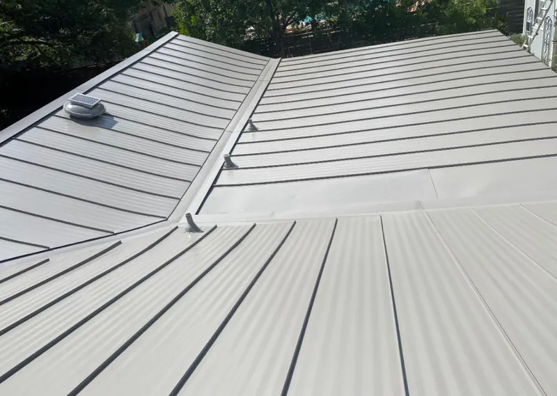 Solar attic fan installed on a metal roof for Roof Ventilation in Booneville